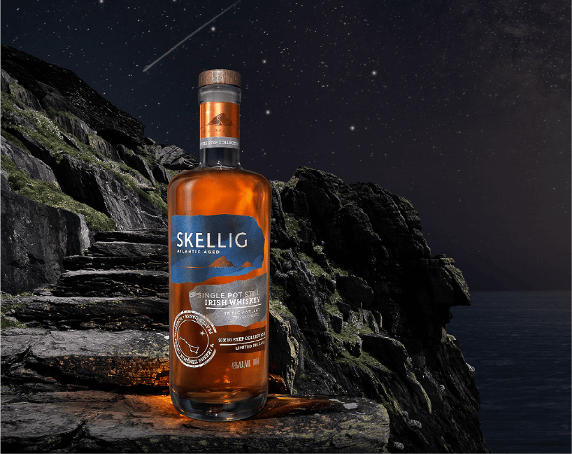 Skellig Single Pot Still bottle under the night sky